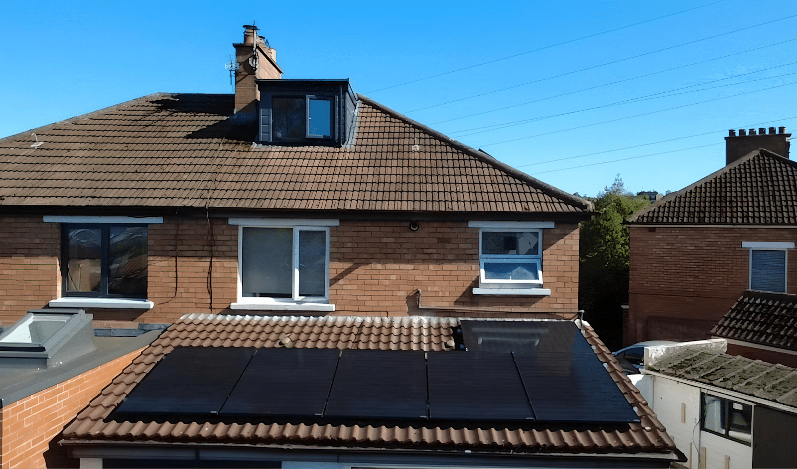 Two-storey semi-detached home with a concrete tile roof and a detached garage, fit for 16 panels.